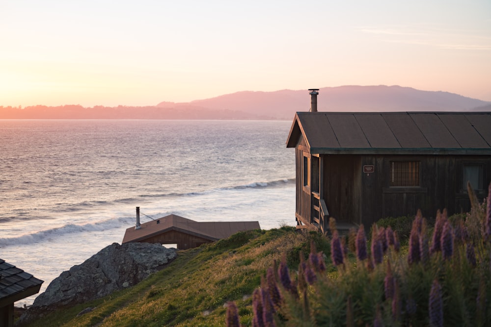 brown wooden house near body of water