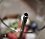 Close-up of a sleek water tumbler with a straw.