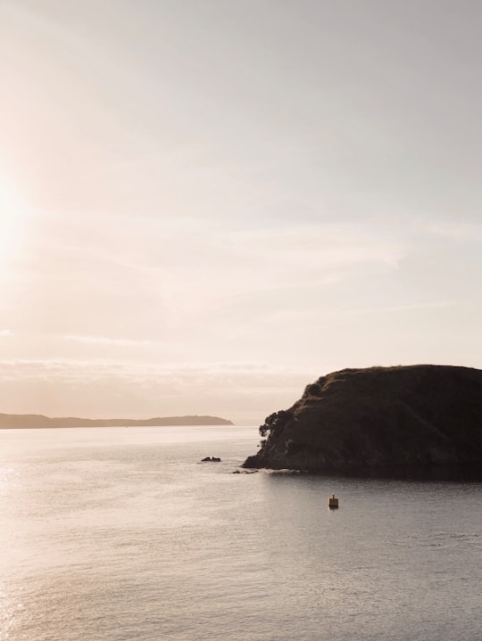 boat sailing near rock of ocean in Waiheke Island New Zealand