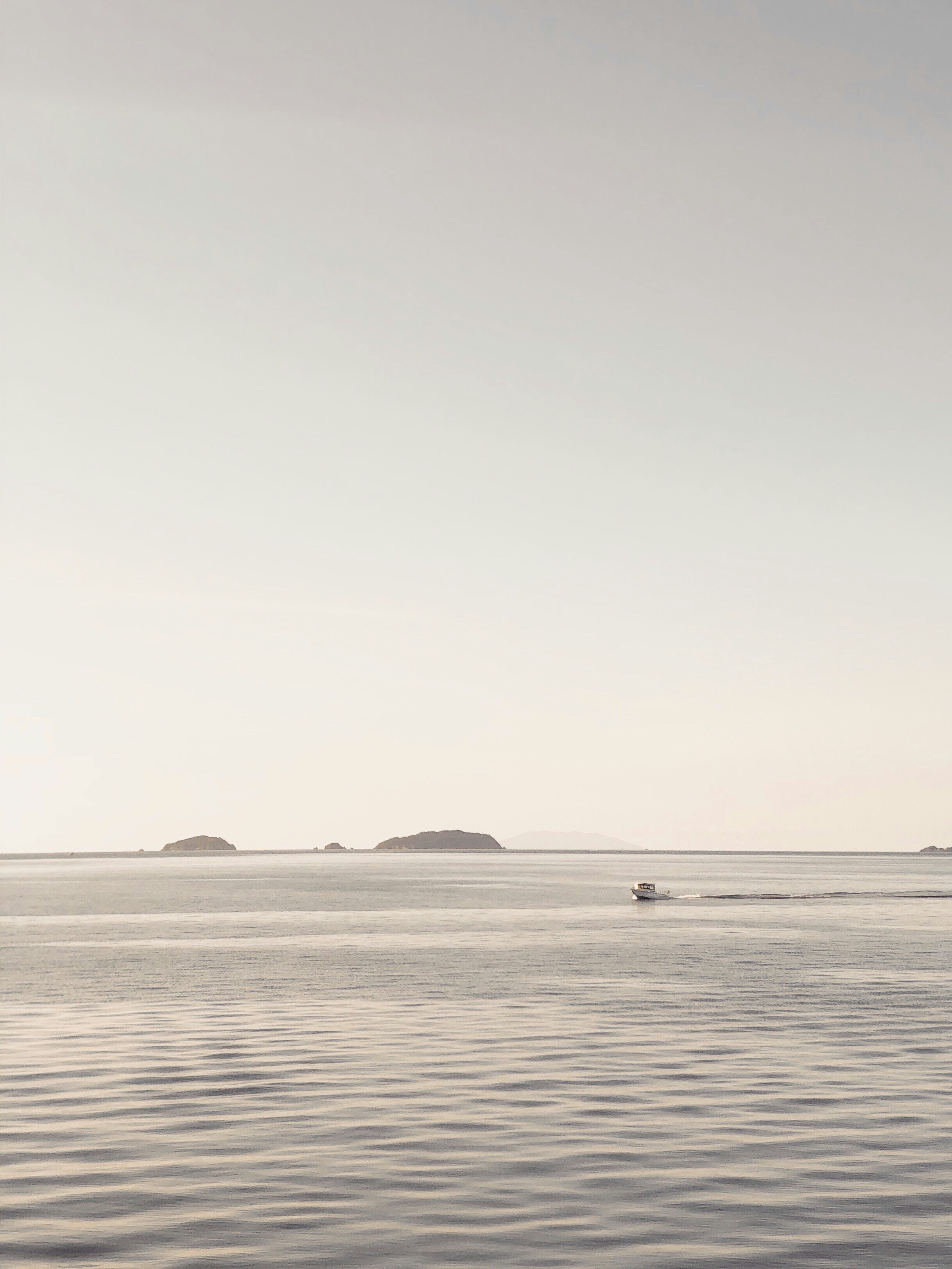 boat on sea under gray sky