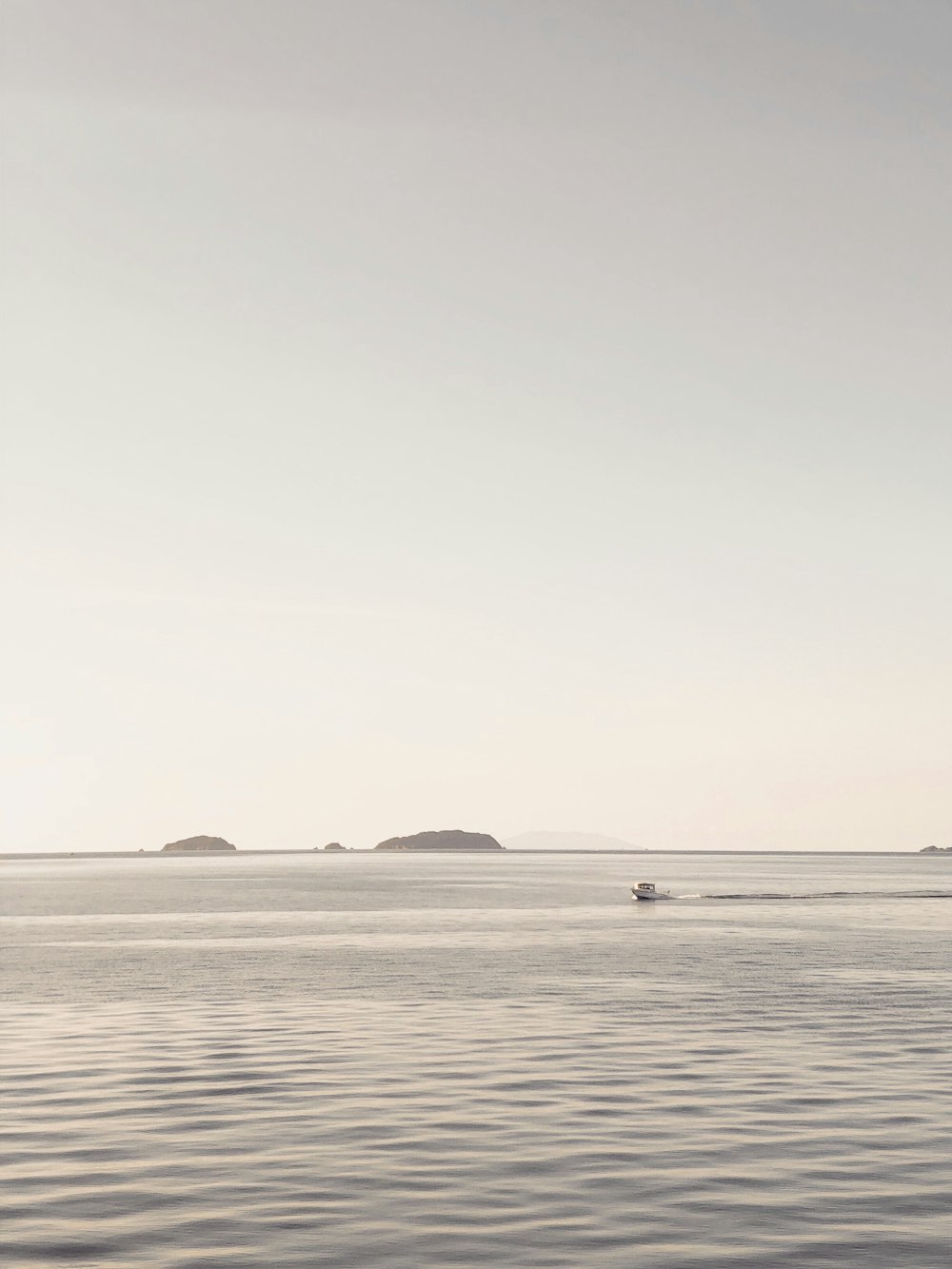 boat on sea under gray sky