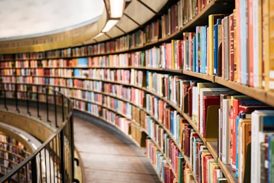 books on brown wooden shelf library teams background