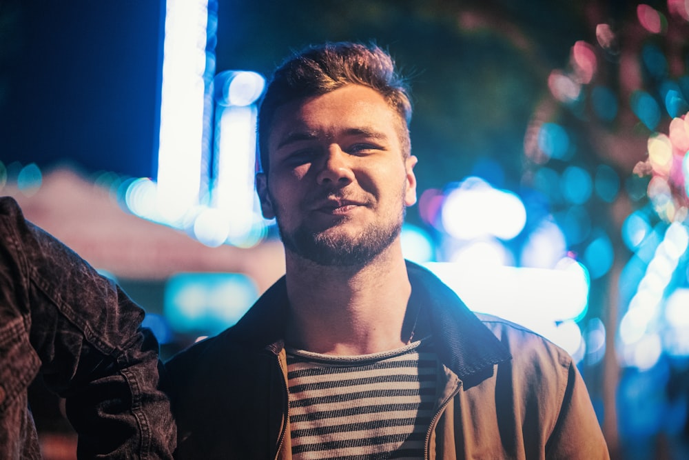 selective focus photography of man wearing brown zip-up jacket