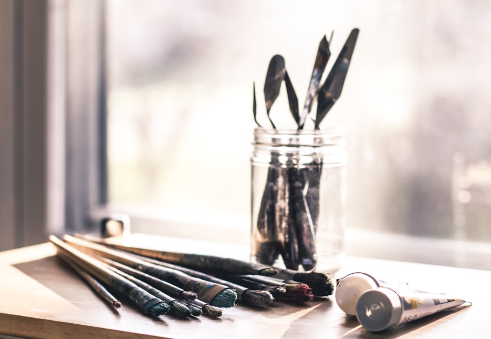 black handled scissors on clear glass jar