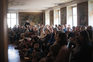A diverse group of people gathered in a church hall.
