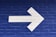 white arrow painted on brick wall