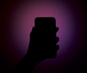 A sleek mobile app prototype displayed on a smartphone with glowing gradient backgrounds.