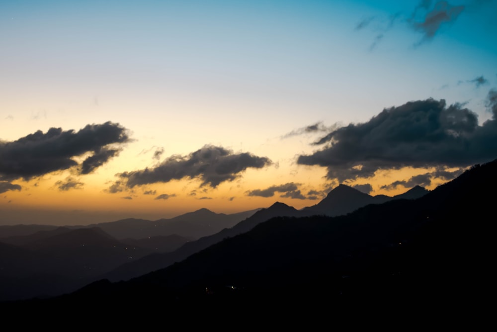 mountains under cloudy sky