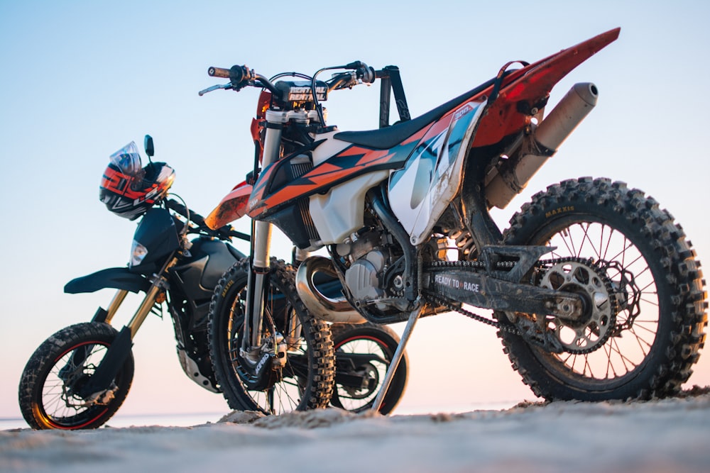 selective focus photography of two white and black dual-sport motorcycles