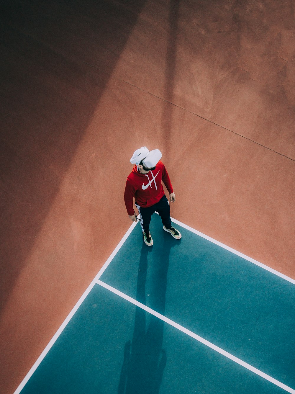 man standing on lawn tennis court