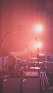 red drum set besides microphone stands