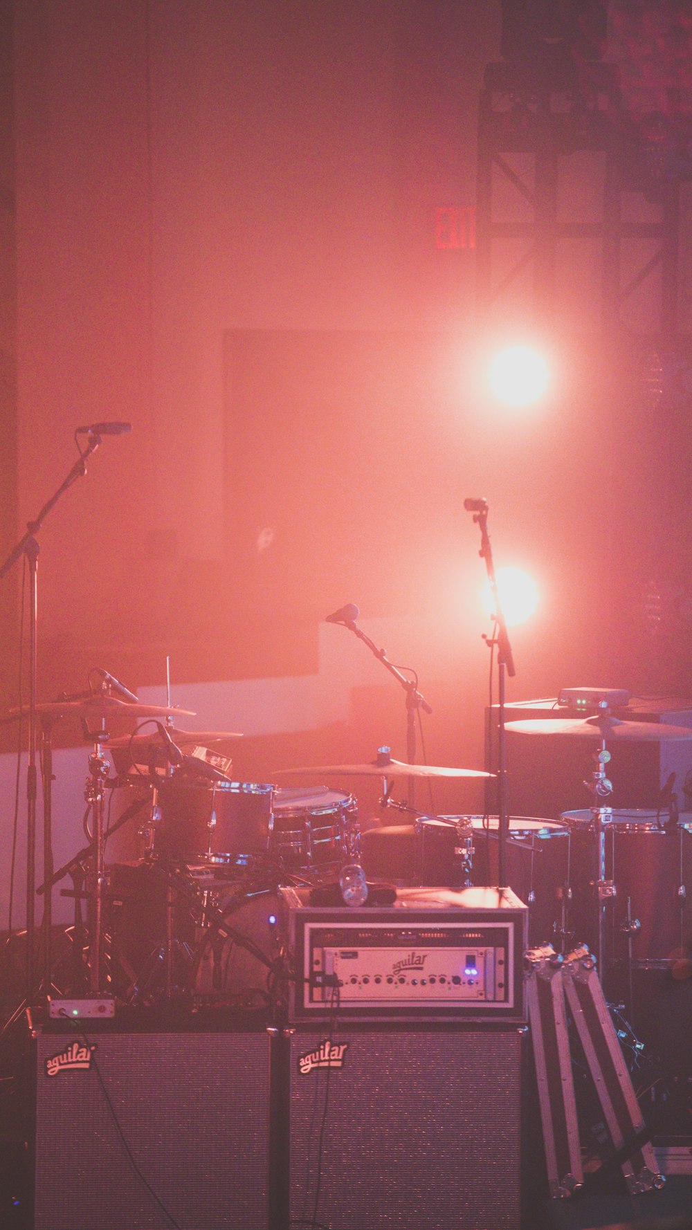 red drum set besides microphone stands