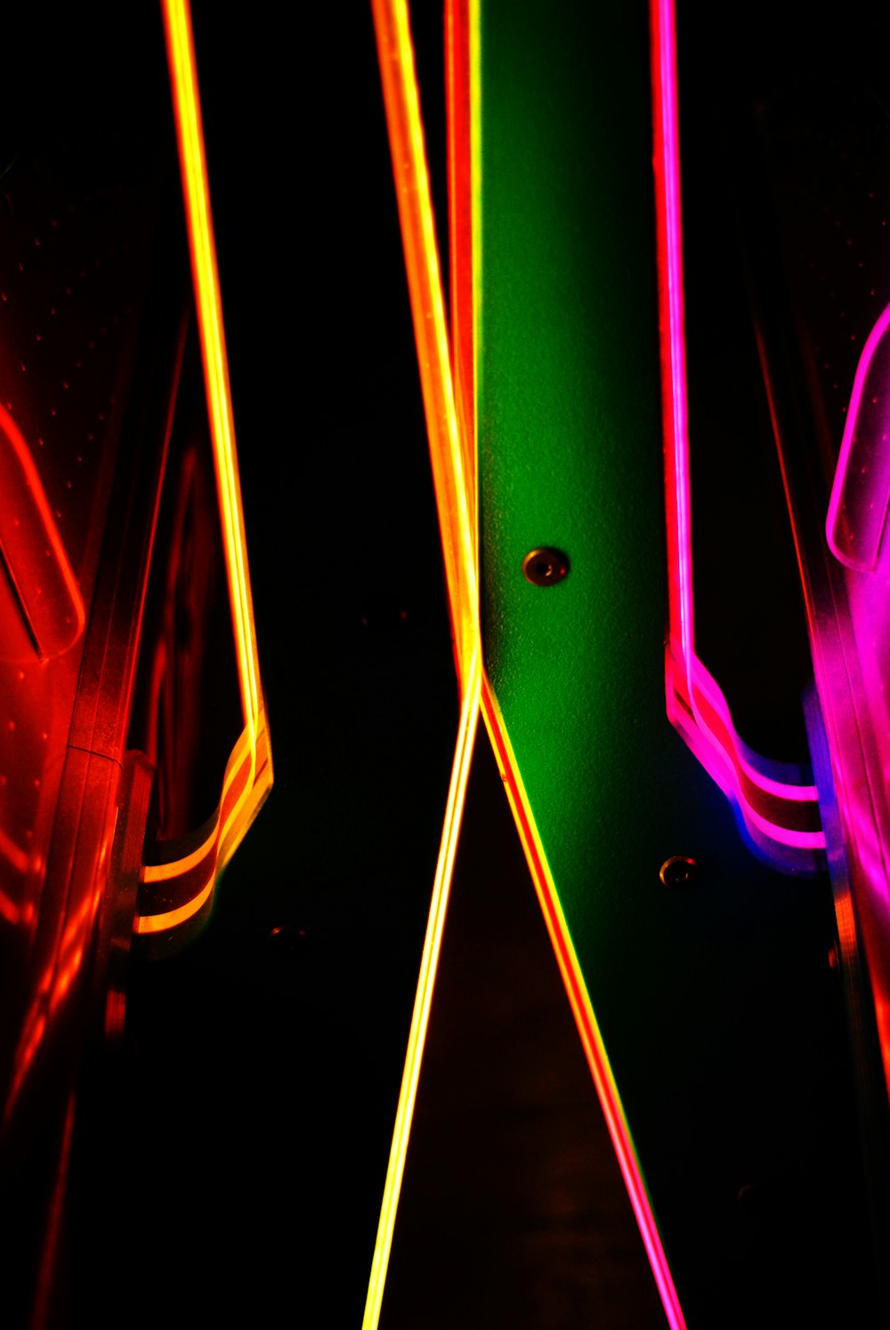 a group of neon lights in a dark room