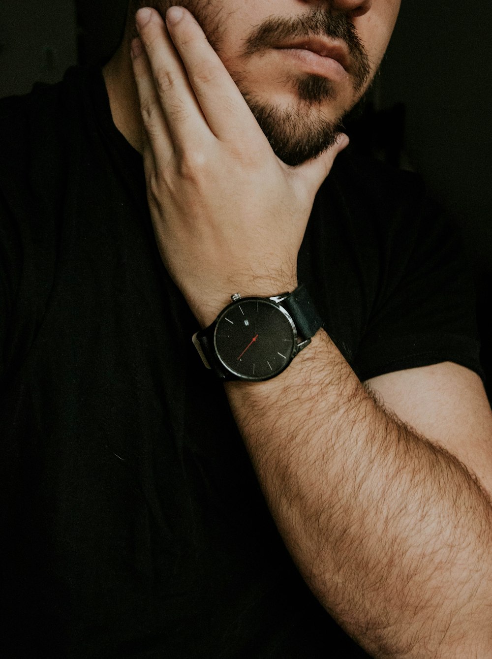 man wearing silver-colored watch holding fave