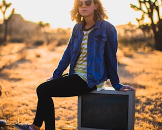 person seating on gray CRT TV