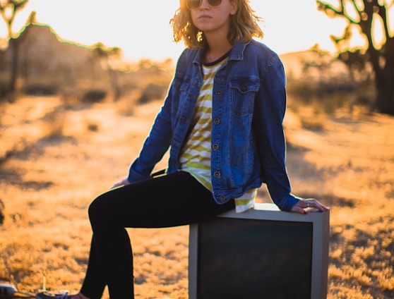 person seating on gray CRT TV