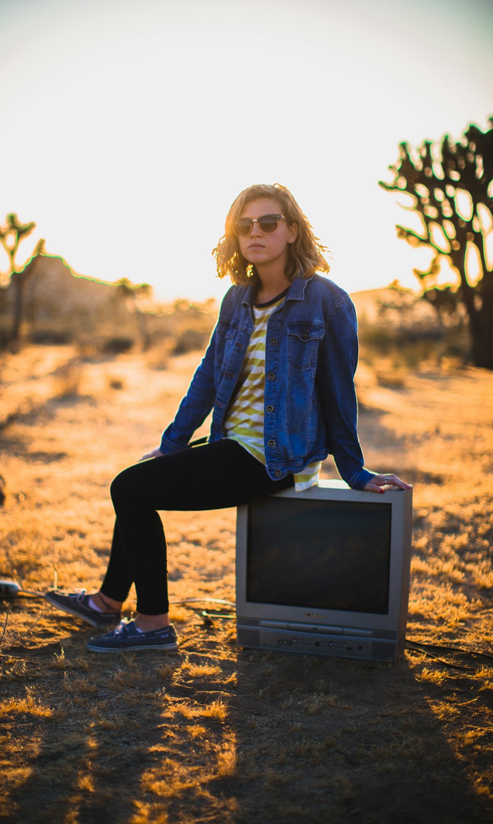 person seating on gray CRT TV