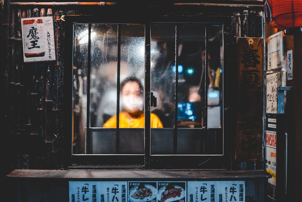 boy standing in front of window