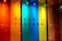 A vibrant display featuring vertical panels of translucent colors, including red, orange, yellow, blue, and green. The text 'COLOR FACTORY' is subtly visible behind the panels, casting a shadow effect.