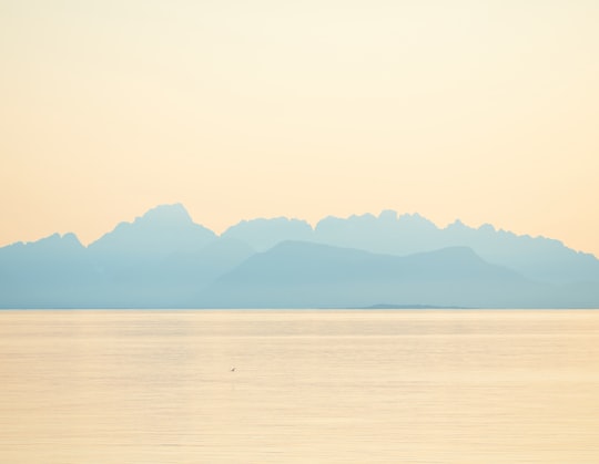 landscape photo of a mountain and body of water in Tranøy Norway