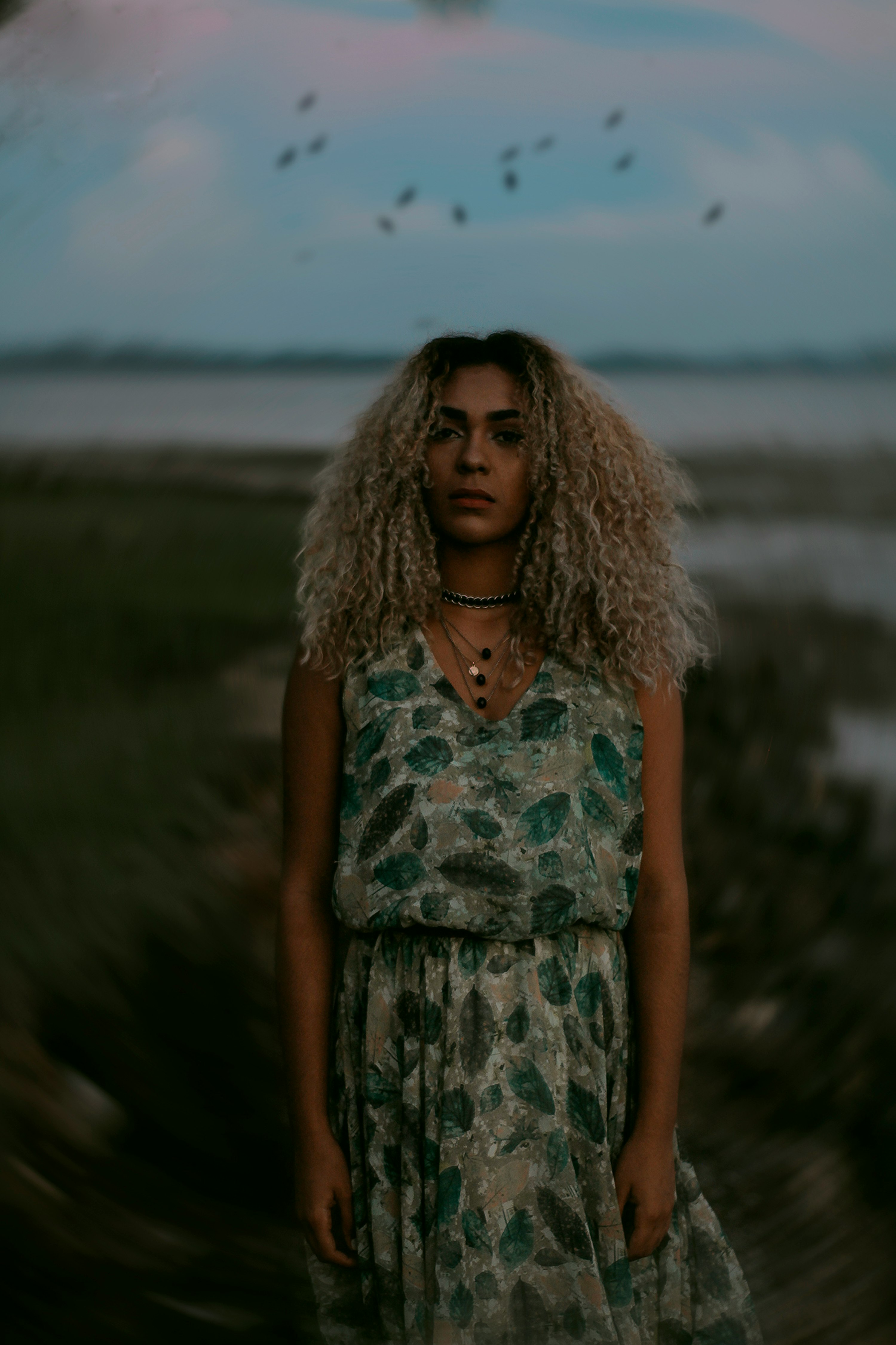 woman posing for photo near sea during daytime