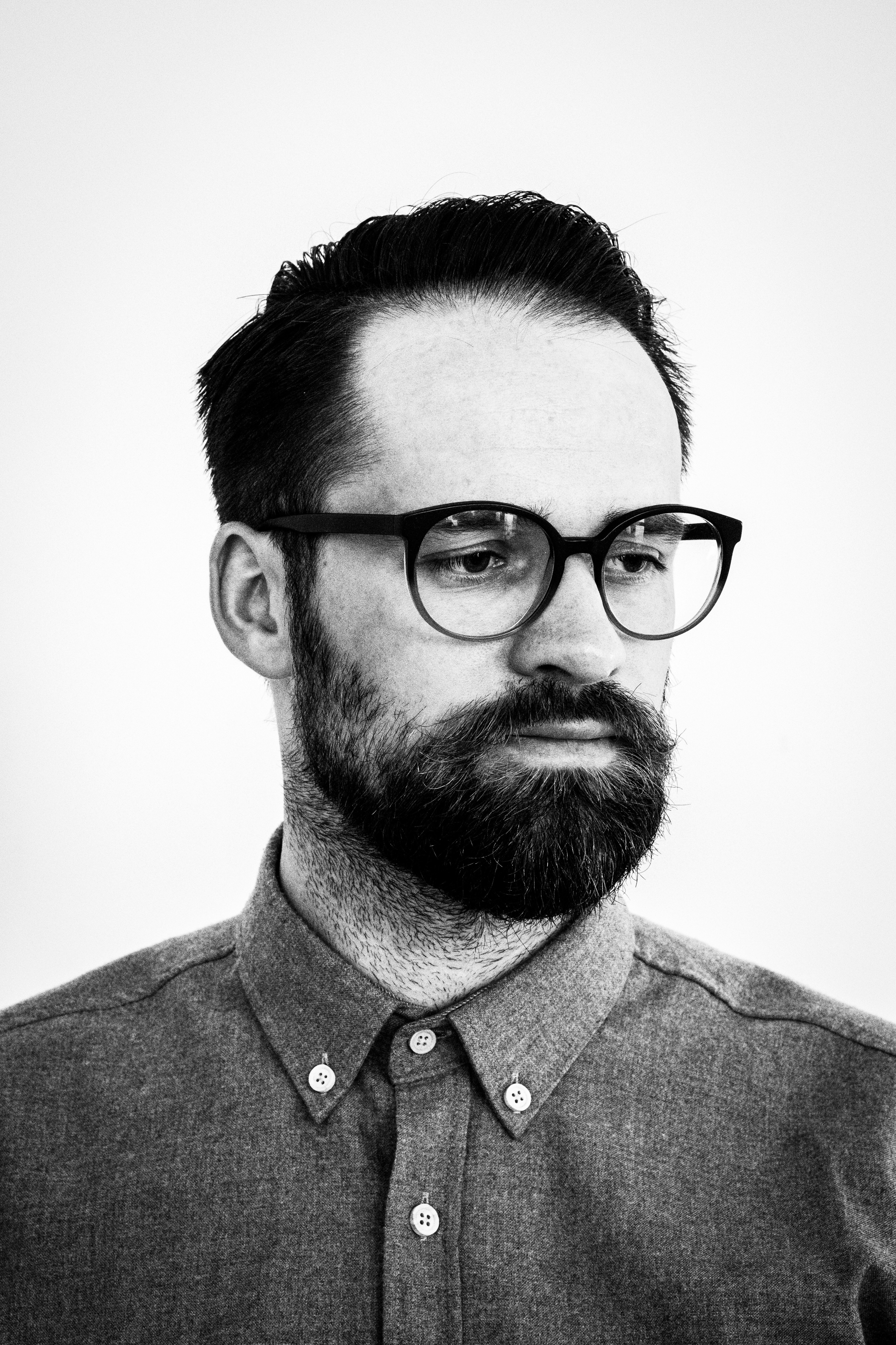 grayscale photo of man wearing button-down dress shirt