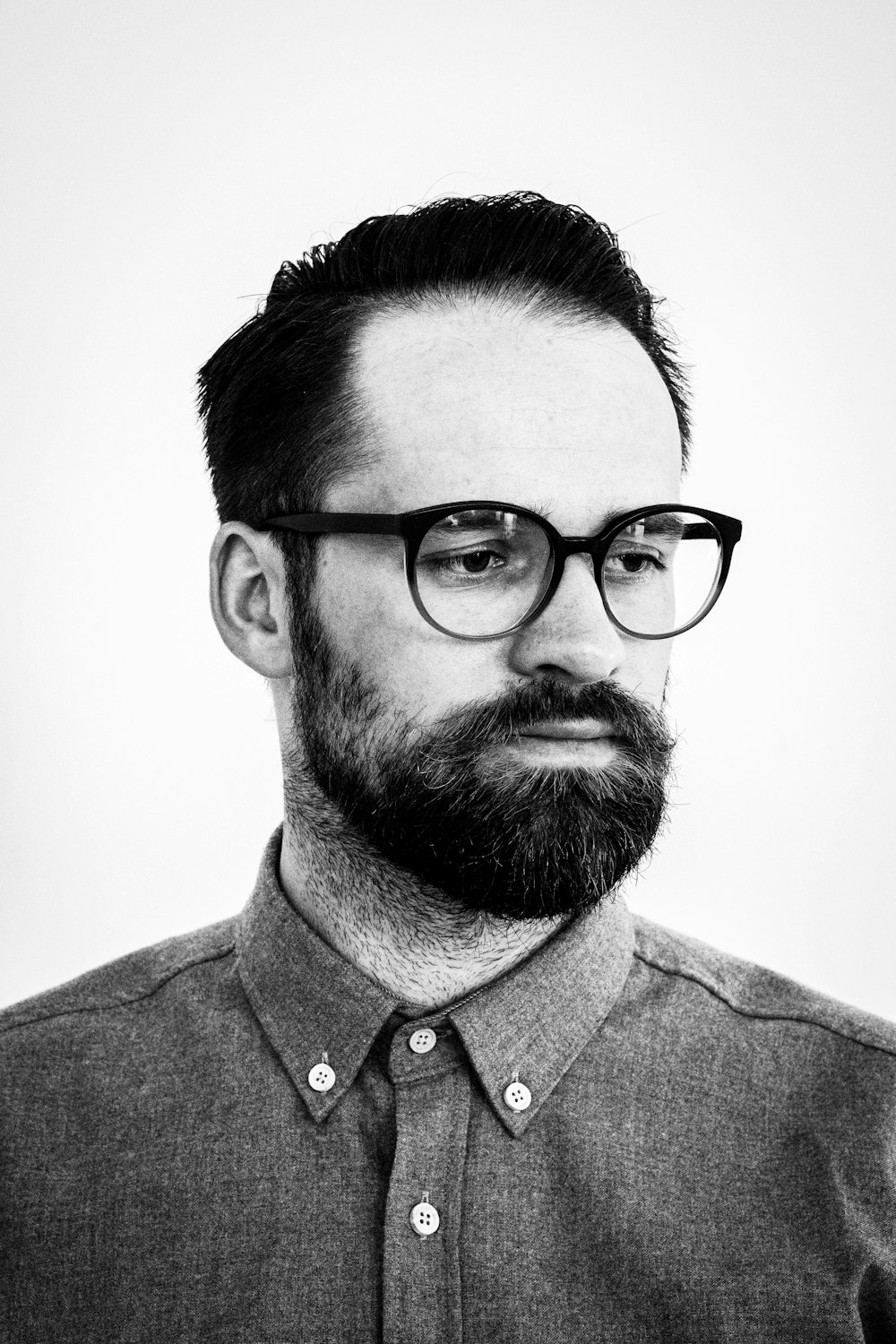 grayscale photo of man wearing button-down dress shirt