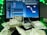A laptop displays a digital audio workstation interface, possibly for music production, with multiple audio tracks and controls visible on the screen. In front of the laptop, there is a scattered pile of currency notes, predominantly Indian rupees. The scene is accented with green lighting.
