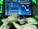 A laptop displays a digital audio workstation interface, possibly for music production, with multiple audio tracks and controls visible on the screen. In front of the laptop, there is a scattered pile of currency notes, predominantly Indian rupees. The scene is accented with green lighting.