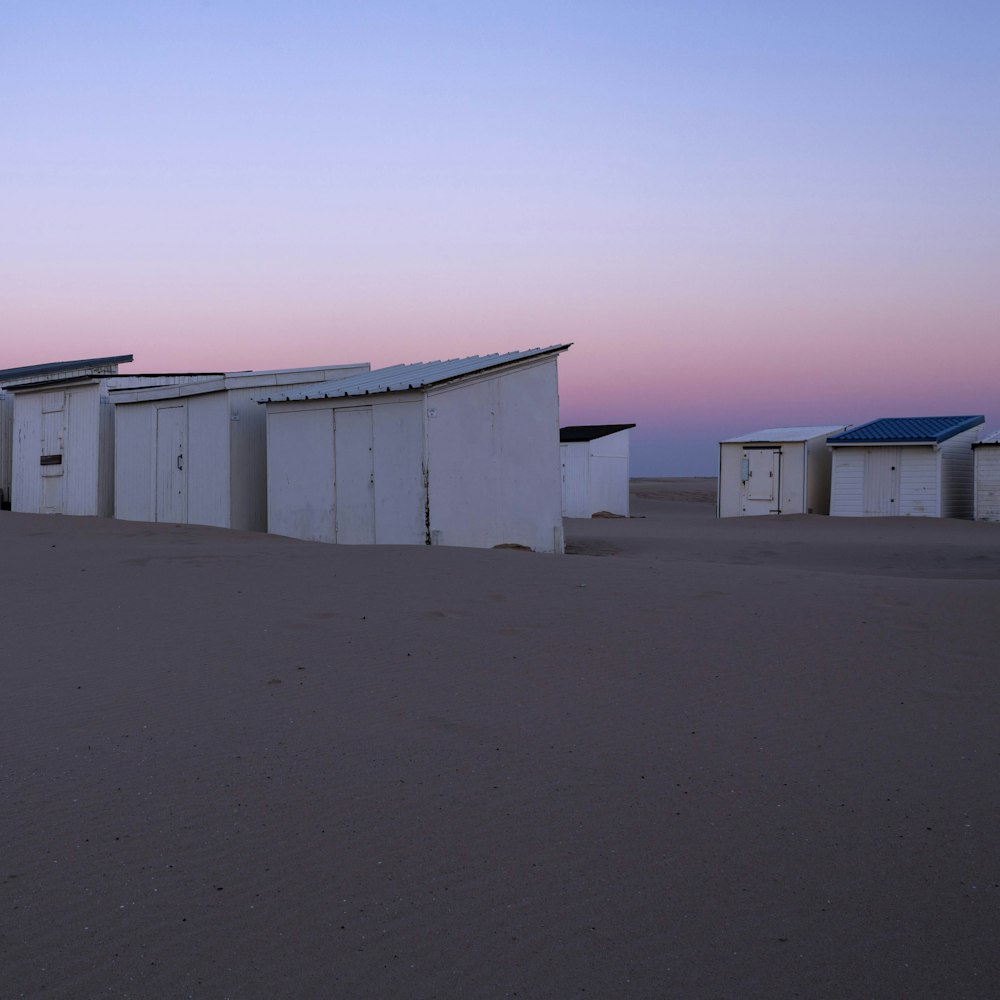 seven white wooden sheds