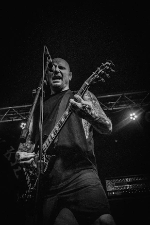 An intimate portrait of a musician performing passionately on stage.