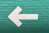 selective focus photography of white arrow signage