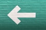 selective focus photography of white arrow signage
