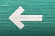 selective focus photography of white arrow signage