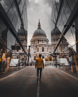 man standing between buildings during daytime