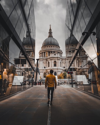 man standing between buildings during daytime