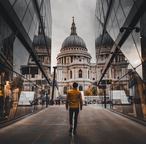 man standing between buildings during daytime