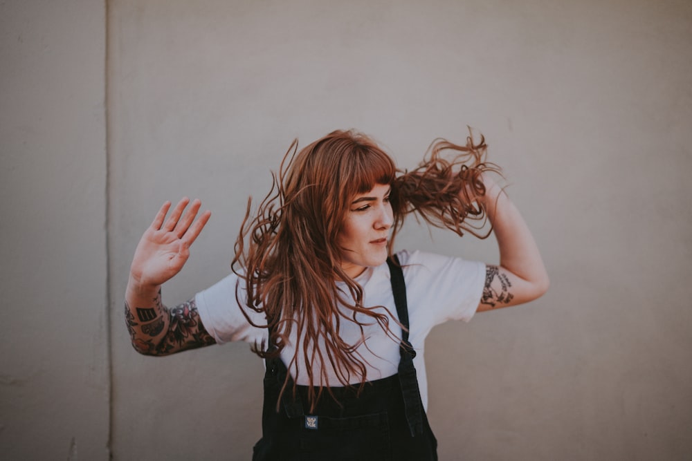 woman holding hair during daytime