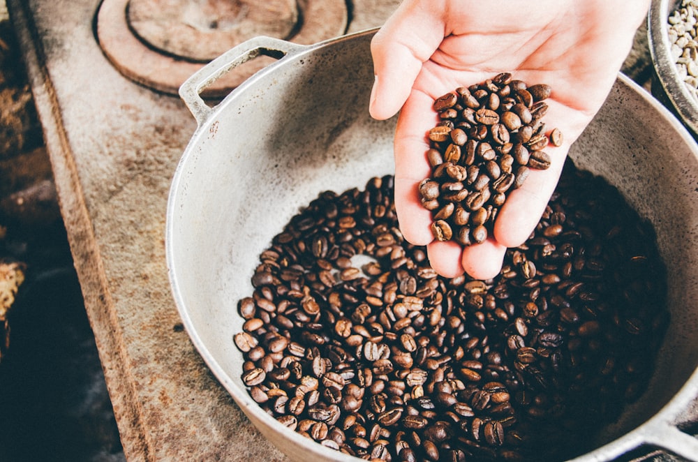 chicchi di caffè su wok in acciaio grigio