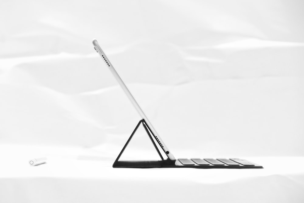 silver iPad on black dock keyboard