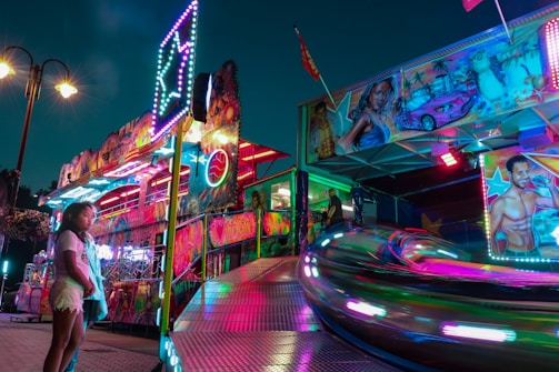 Vibrant amusement park entrance adorned with colorful themed sculptures and lights.