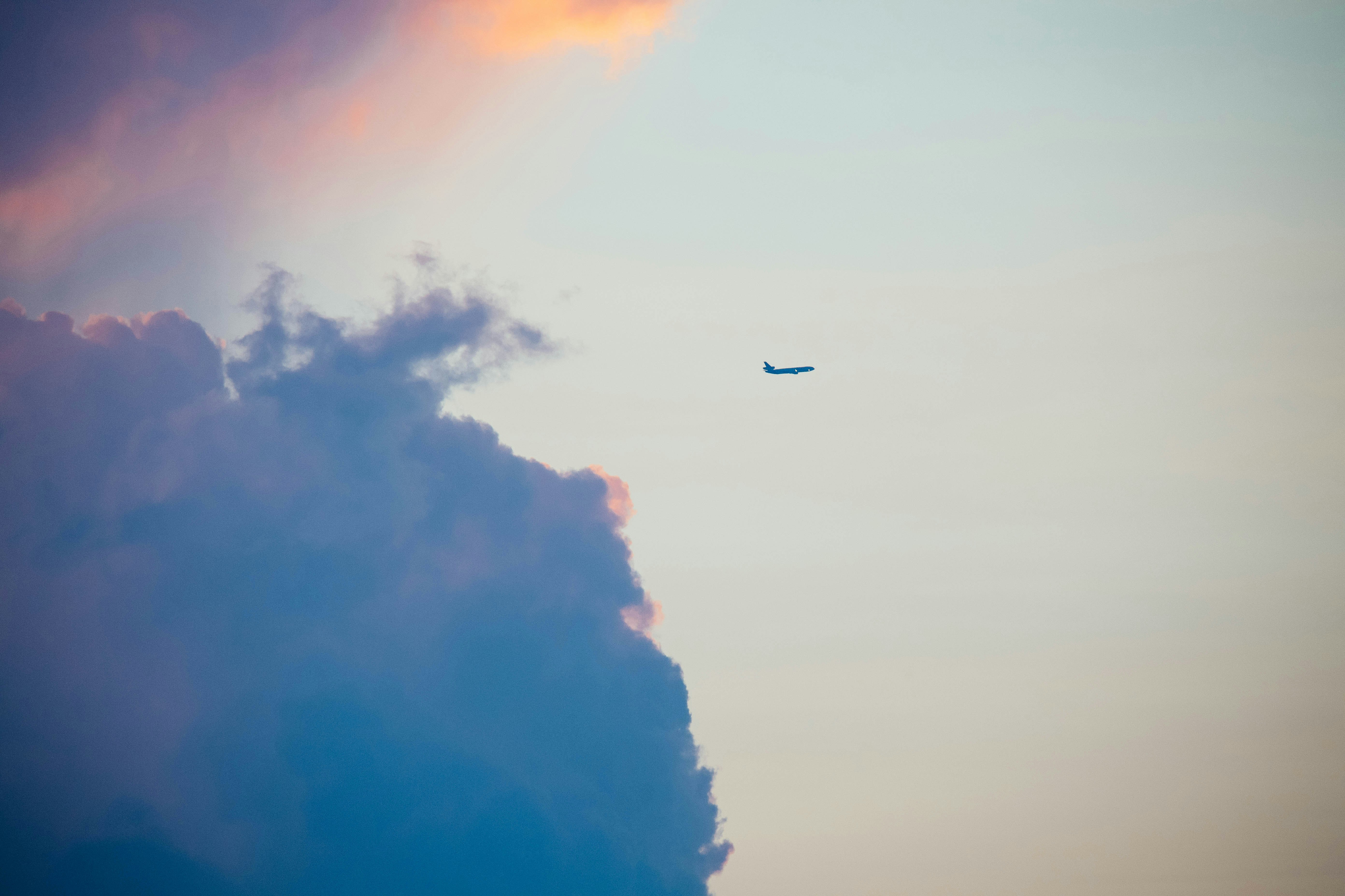 plane on the sky and nimbus clouds