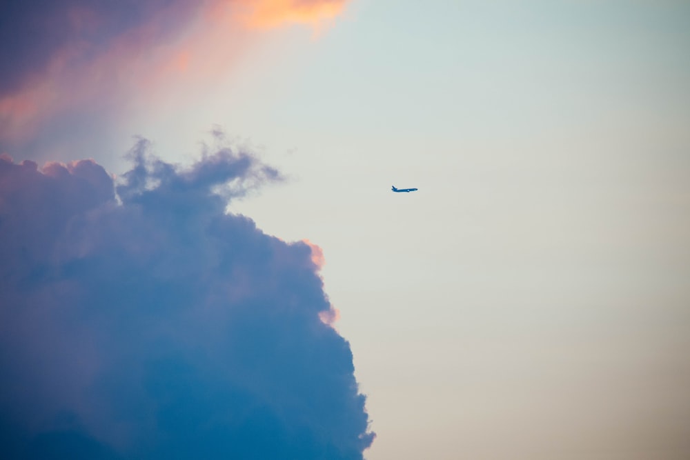 plane on the sky and nimbus clouds