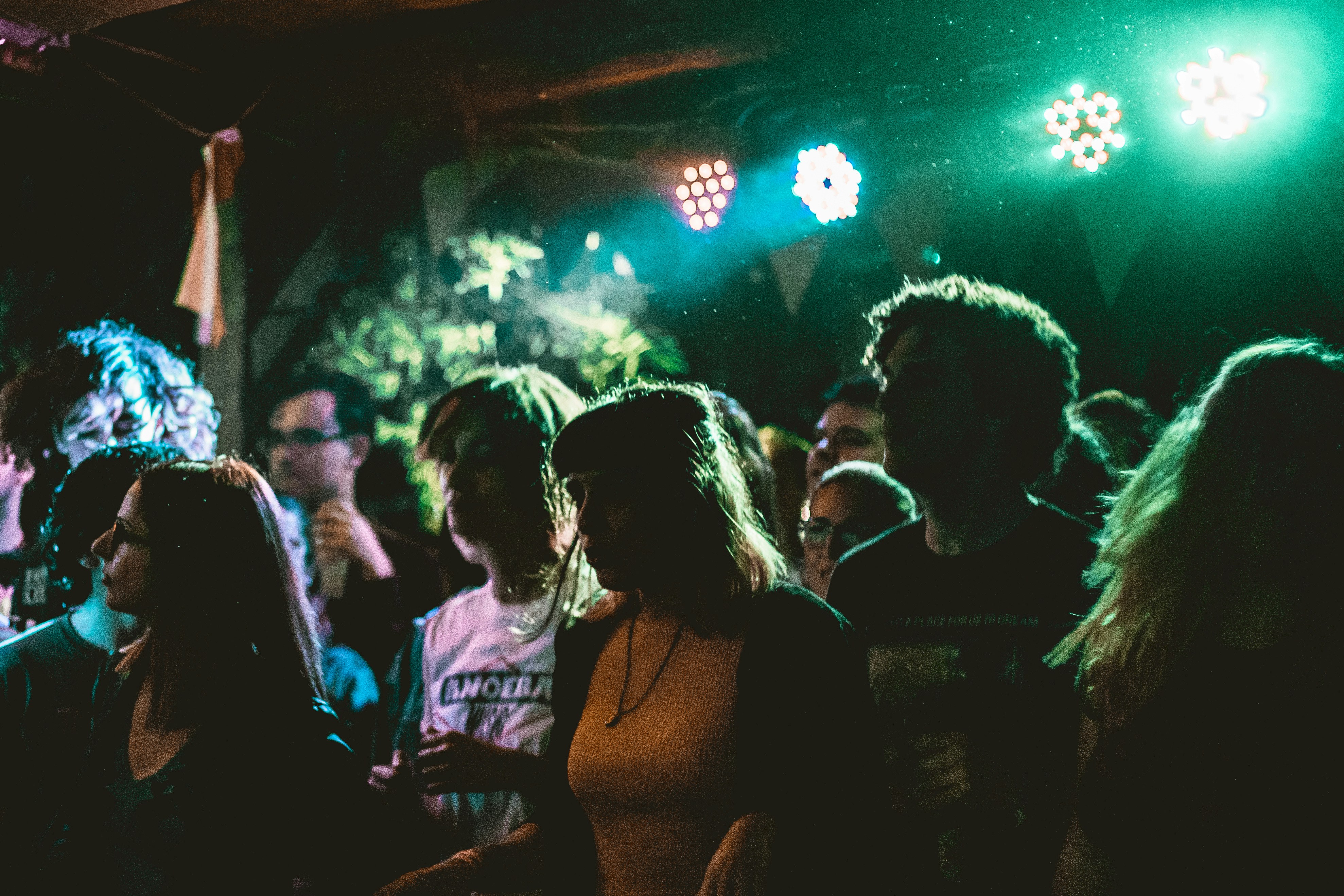people inside the club with disco lights