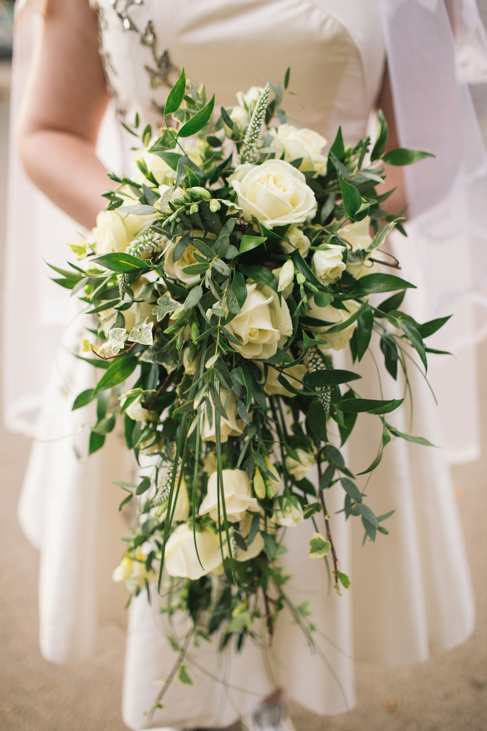 woman holding white roses bouquet