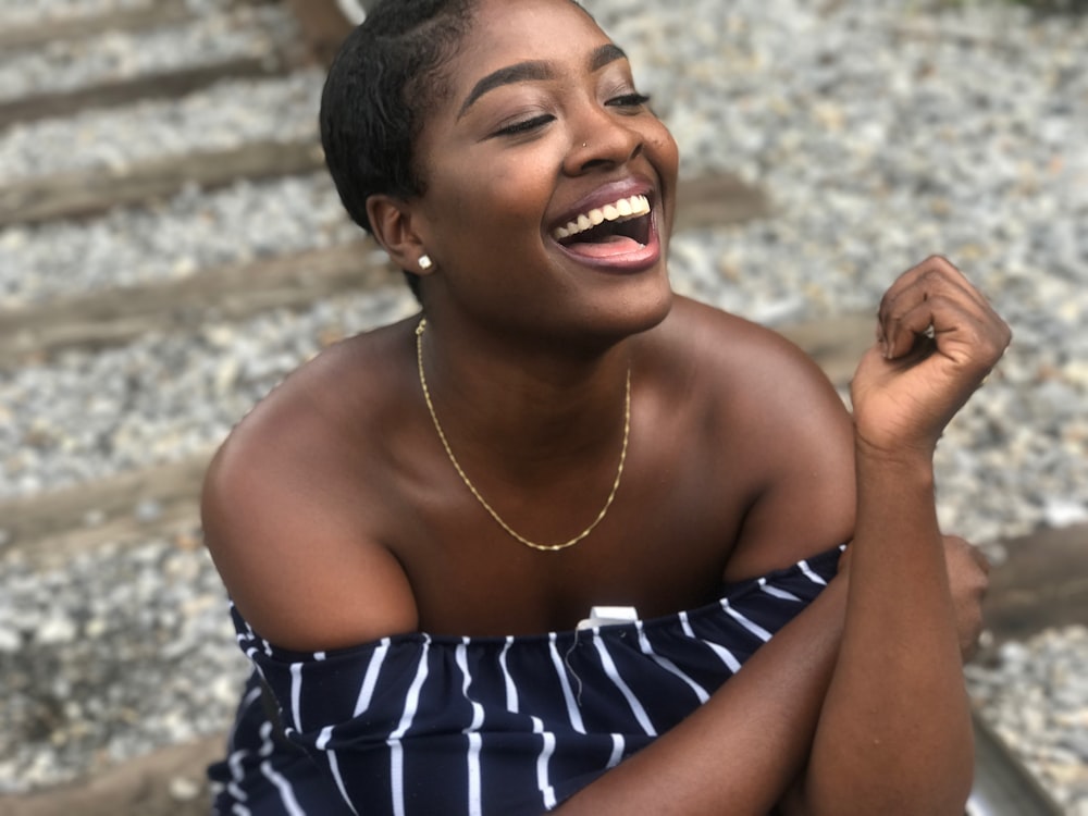 candid shot of woman wearing black and white striped off-shoulder top