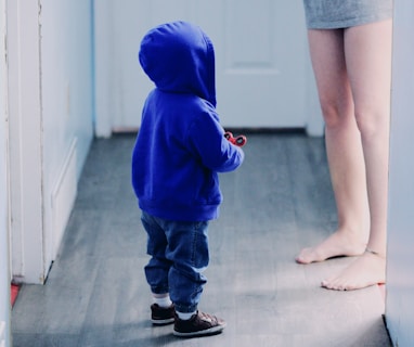 toddler in blue hooded jacket