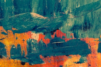 A vibrant abstract painting featuring bold brushstrokes and contrasting colors. The artwork displays a mix of teal blue and vivid orange with hints of yellow, creating a dynamic and textured composition.