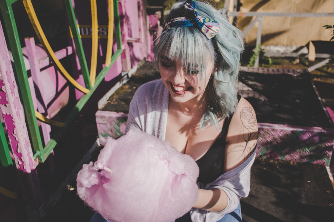 closeup photo of woman holding cotton candy