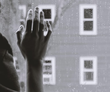 grayscale photo of woman right hand on glass